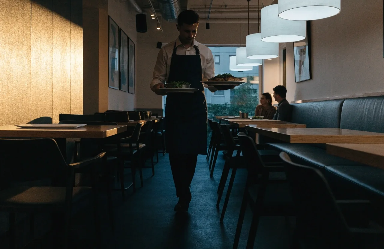 A quieter casual seafood grill dining room mid-service with a table of two and grilled fish plated at the center
